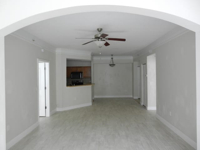 unfurnished living room featuring ceiling fan, crown molding, and light hardwood / wood-style flooring