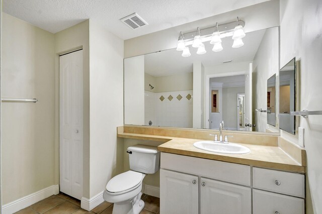 bathroom with tiled shower / bath and tile patterned flooring