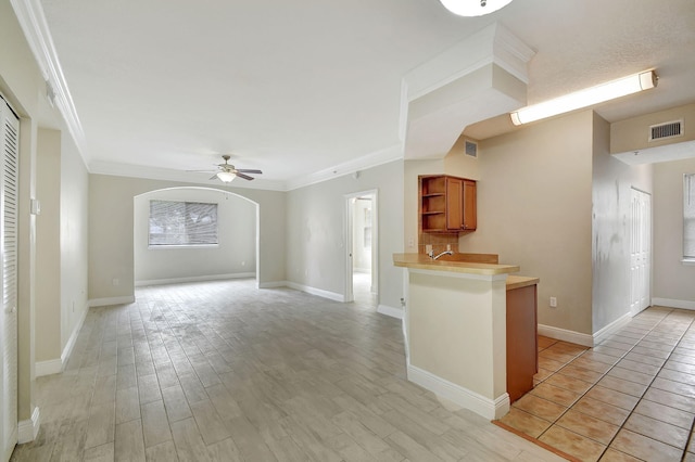 living room with crown molding, a towering ceiling, and hardwood / wood-style floors