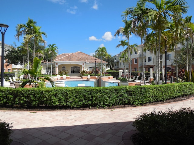 view of patio featuring ceiling fan and exterior bar