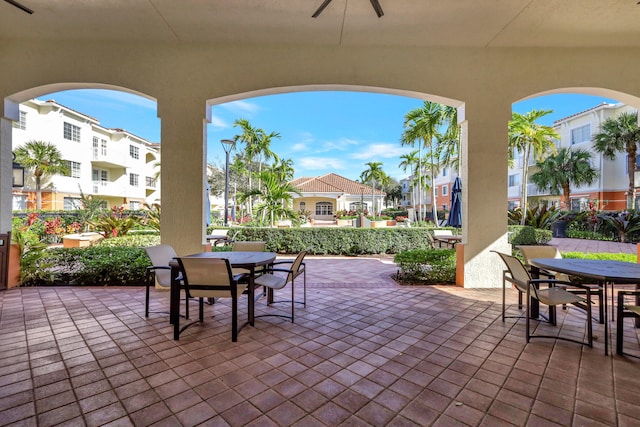 view of patio / terrace with ceiling fan and an outdoor bar