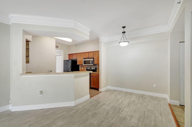 sitting room featuring light wood-type flooring, ornamental molding, and decorative columns