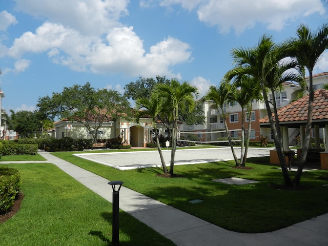 surrounding community featuring volleyball court and a lawn