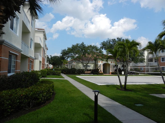 surrounding community featuring a yard and volleyball court