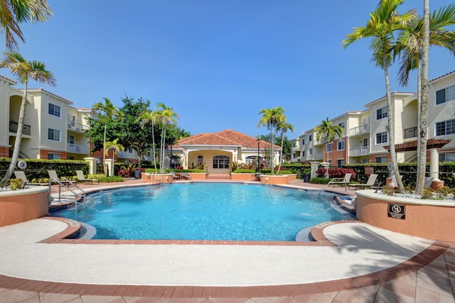 view of pool featuring pool water feature and a patio area