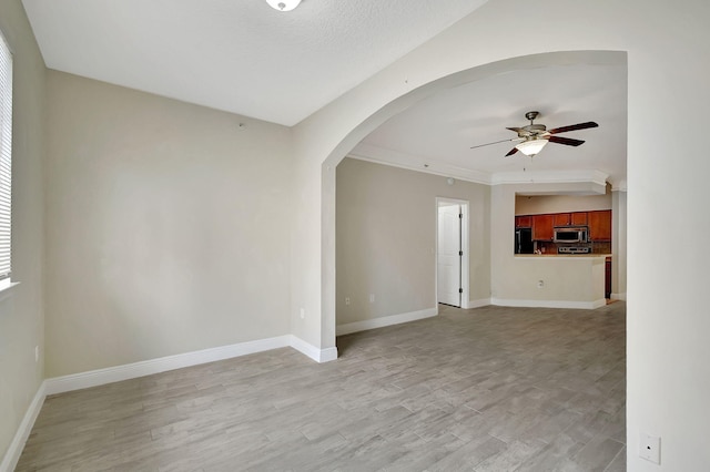 living room with a high ceiling, ornate columns, a wealth of natural light, and light hardwood / wood-style flooring