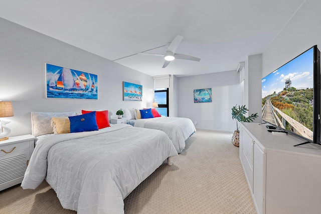 bedroom featuring light carpet, ceiling fan, and multiple windows