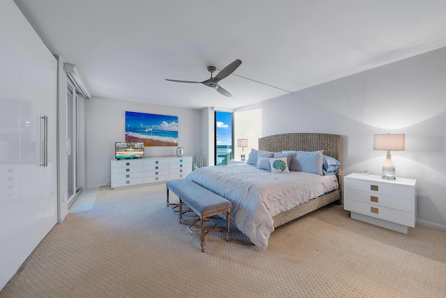 bedroom with ceiling fan and light colored carpet