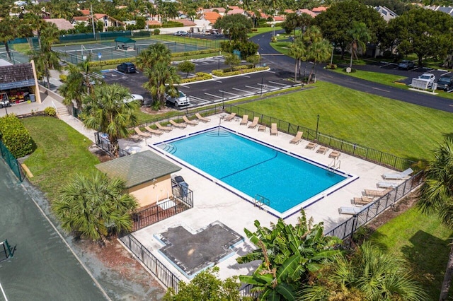 view of swimming pool with a patio area and a yard