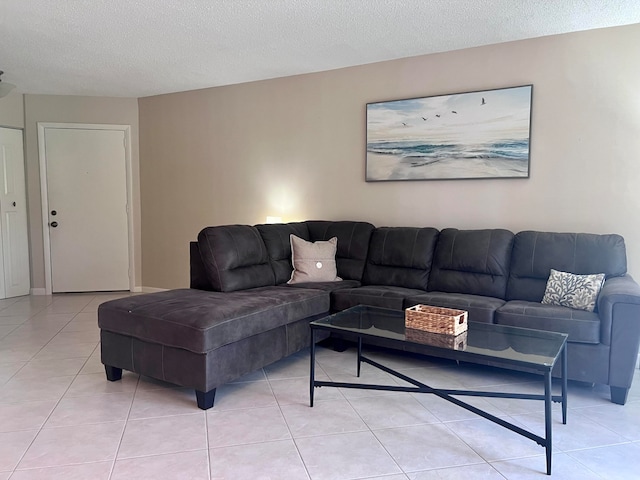 living room with a textured ceiling and light tile floors