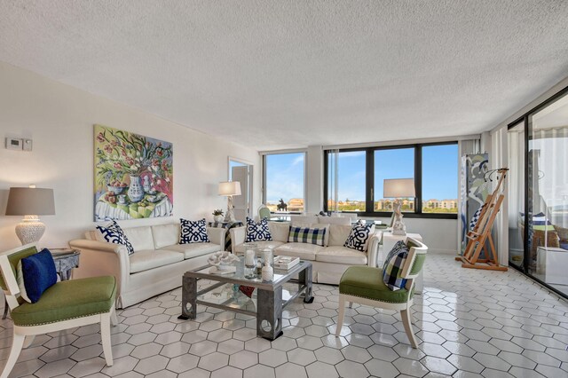 tiled living room with a textured ceiling and ceiling fan