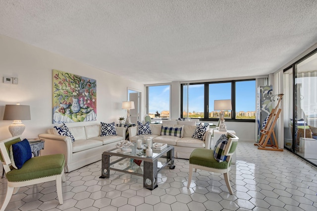 living room featuring floor to ceiling windows, tile floors, and a textured ceiling