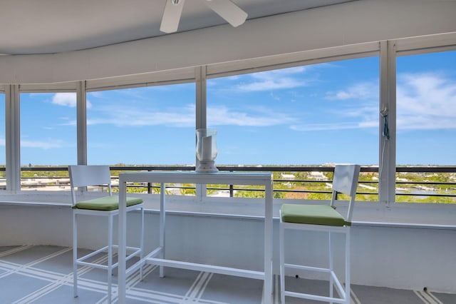 unfurnished sunroom with a healthy amount of sunlight and ceiling fan