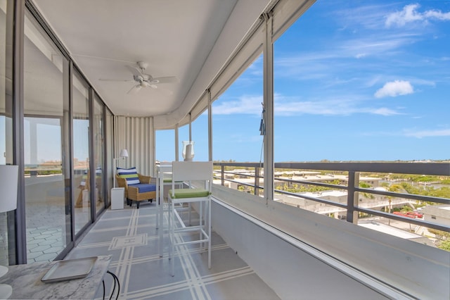 unfurnished sunroom featuring ceiling fan