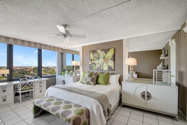 bedroom with light tile patterned floors, a textured ceiling, and a ceiling fan