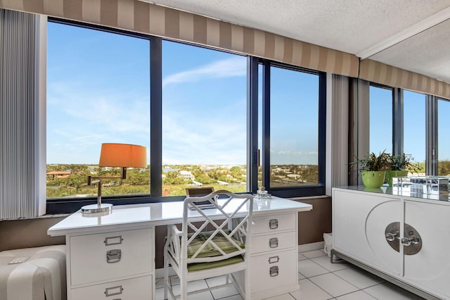 office area featuring a wealth of natural light, light tile patterned floors, and a textured ceiling