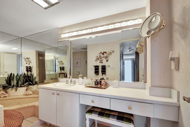 full bathroom with visible vents, vanity, and a bath