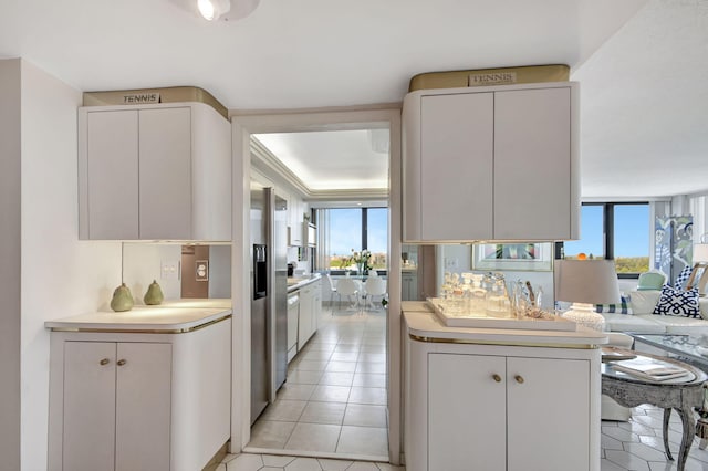 kitchen with light tile patterned floors, light countertops, and a wealth of natural light