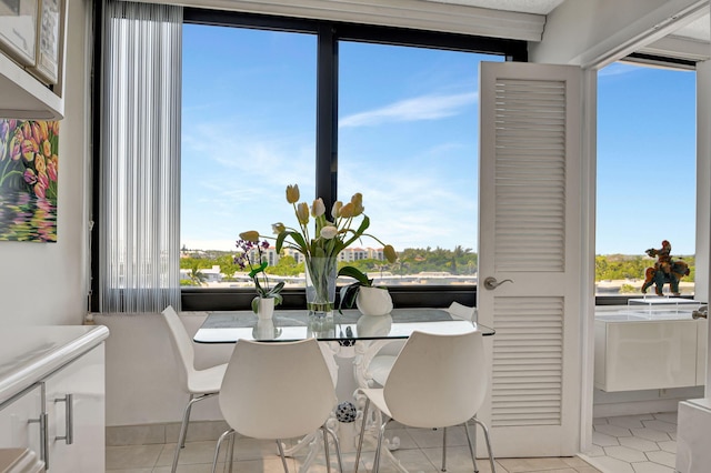 dining area featuring light tile patterned floors