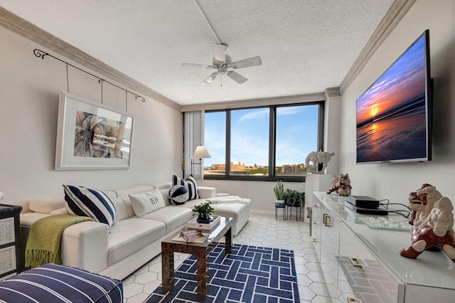 tiled living room featuring ceiling fan, ornamental molding, and a textured ceiling