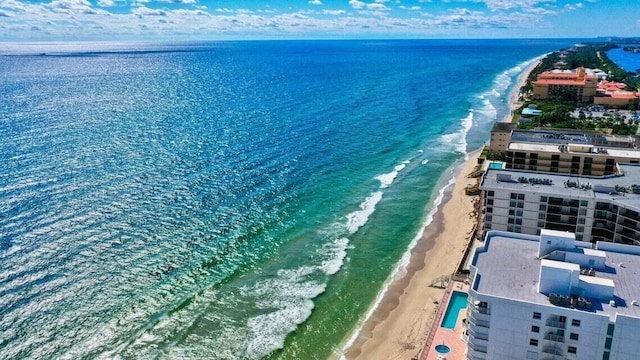 birds eye view of property with a beach view and a water view