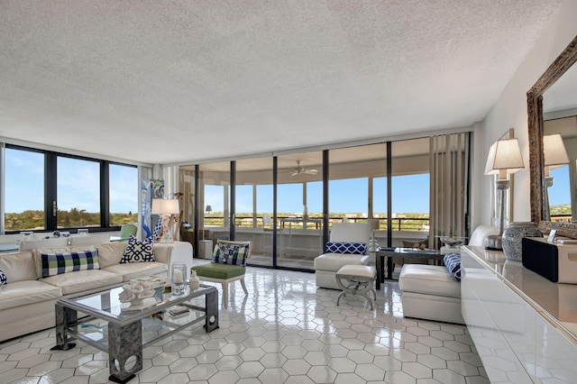 living room with expansive windows, a textured ceiling, and tile patterned floors