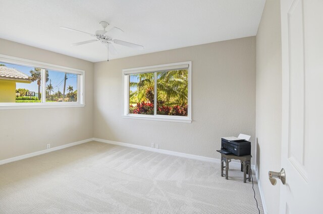 interior space featuring light carpet and ceiling fan