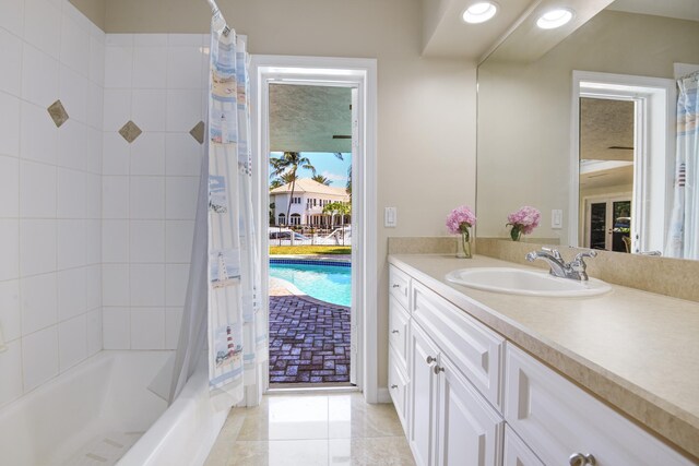 bathroom featuring vanity, tile patterned flooring, and shower / bath combo with shower curtain