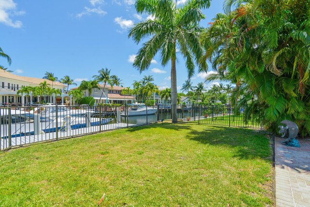 view of yard with a community pool and a water view