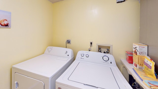 clothes washing area featuring independent washer and dryer