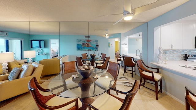 tiled dining room with ceiling fan