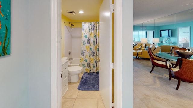 bathroom with tile patterned flooring, shower / bathtub combination with curtain, and toilet