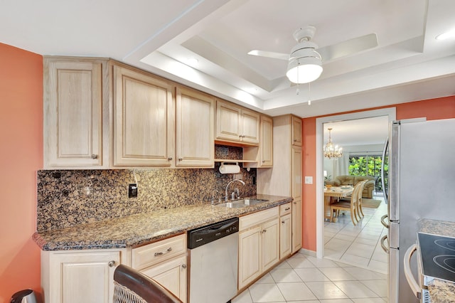 kitchen featuring a raised ceiling, ceiling fan with notable chandelier, stainless steel dishwasher, and light tile floors