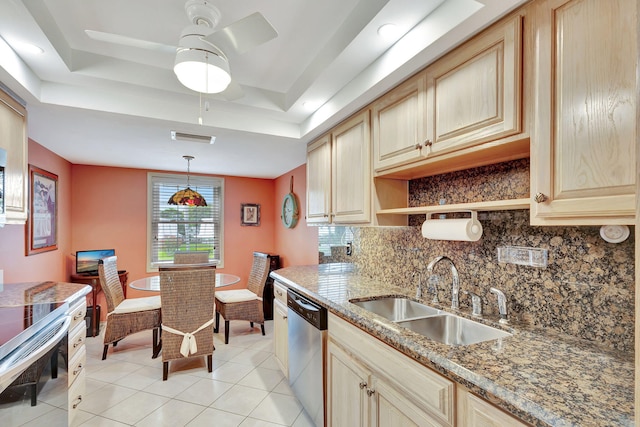 kitchen featuring backsplash, light tile floors, sink, and a raised ceiling