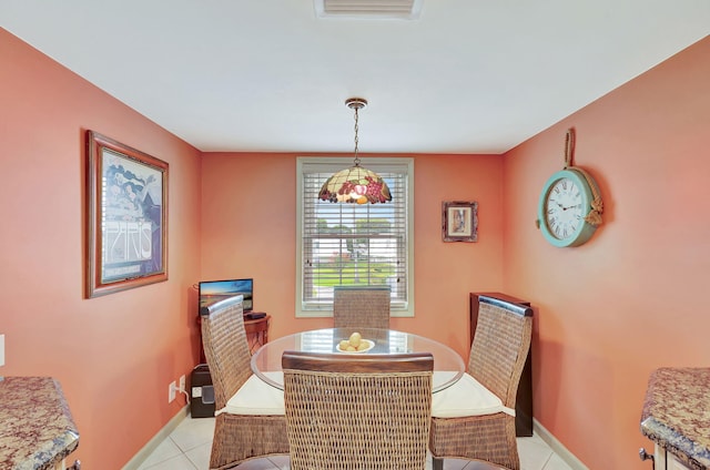 dining area featuring light tile floors