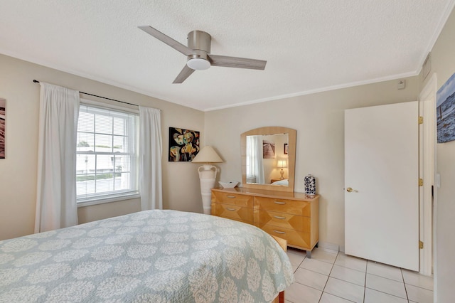 tiled bedroom with a textured ceiling, ornamental molding, and ceiling fan