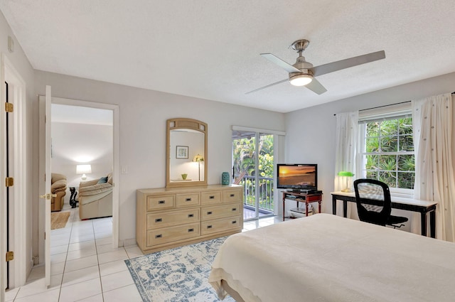 bedroom with ceiling fan, a textured ceiling, light tile flooring, and access to outside