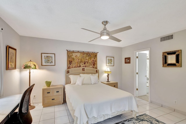 bedroom with ensuite bathroom, light tile flooring, and ceiling fan