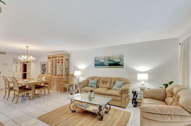 living room with a textured ceiling, light tile floors, and a chandelier