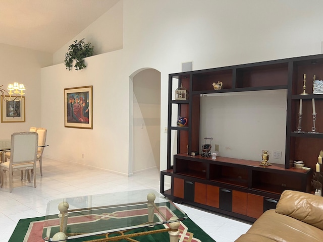 living room with high vaulted ceiling and light tile floors