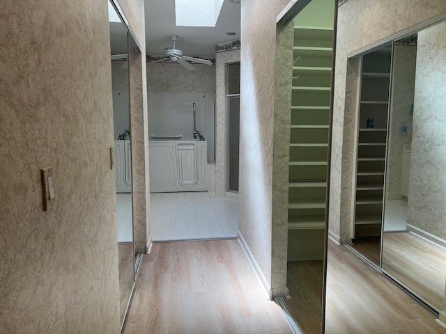 interior space featuring a skylight, washer / clothes dryer, and tile flooring