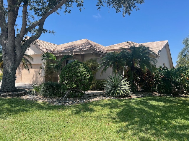 view of side of property with a garage and a yard