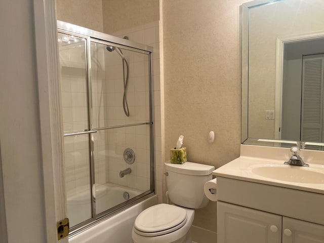 full bathroom featuring enclosed tub / shower combo, toilet, and vanity