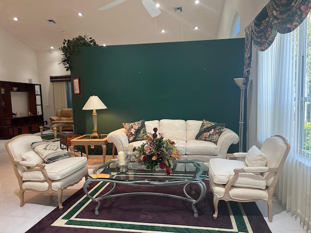 living room with high vaulted ceiling, ceiling fan, and light tile floors