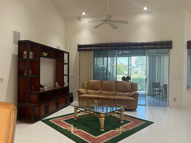 tiled living room with high vaulted ceiling and ceiling fan