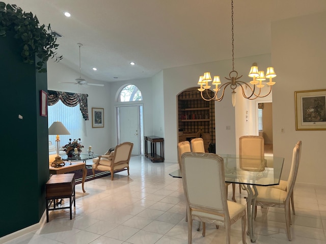 dining space featuring high vaulted ceiling, ceiling fan with notable chandelier, and light tile floors