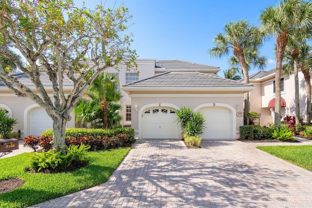 mediterranean / spanish home with a garage