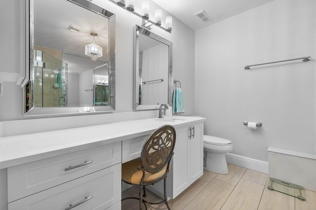 bathroom featuring vanity, toilet, and an enclosed shower