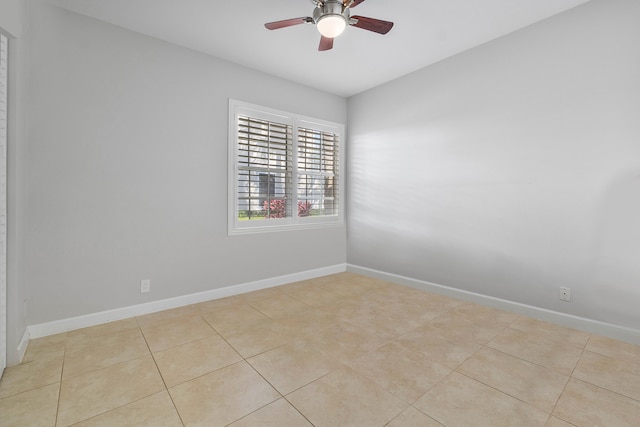 tiled spare room with ceiling fan