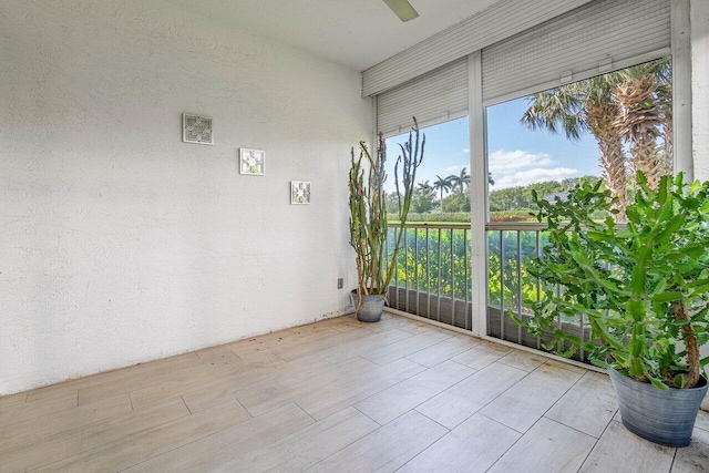 unfurnished sunroom with a water view